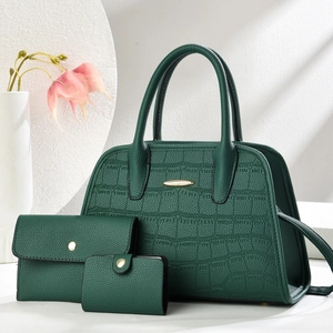 Three-piece dark green handbag set with crocodile and litchi texture on white background