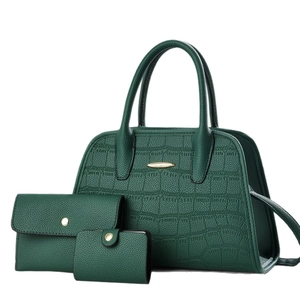 Three-piece forest green handbag set with textured leather and gold hardware accents