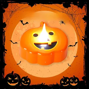 Detail of orange Halloween LED pumpkin candle with glowing face against a spooky moon