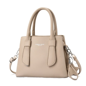 Large beige leather tote bag with top handles and adjustable shoulder strap for women