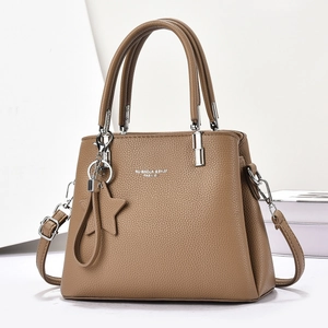 Caramel brown pebbled leather tote bag with star charm and adjustable silver hardware strap