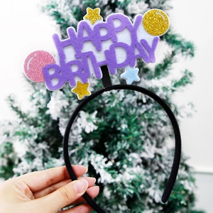 Detailed view of purple Happy Birthday headband with gold stars on a black band