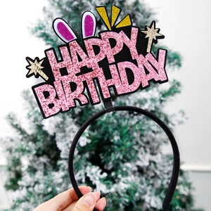 Close-up of pink glitter Happy Birthday letters with purple bunny ears on a headband