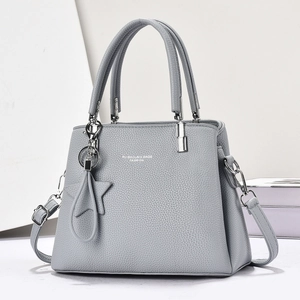 Grey pebbled leather handbag with silver hardware and star charm accessory