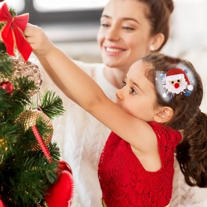 Detail of child wearing a Santa Claus hair clip with sequins and mesh during Christmas decor