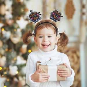 Girl wearing Cheers to the New Year headband with silver spring balls for holiday party
