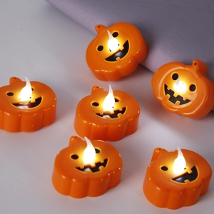 Set of six orange LED pumpkin tea lights with smiling faces for Halloween party decor