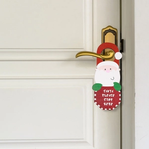 Detail of wooden Santa door hanger with Santa Please Stop Here text on door handle