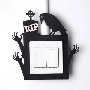 Halloween light switch decor with black felt frame featuring tombstone and skull hands