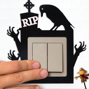Detail showing a Halloween RIP tombstone felt wall sticker surrounding a light switch plate