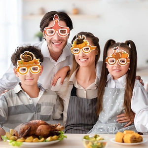 Family wearing Thanksgiving party paper glasses with turkey and pumpkin designs