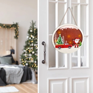 Close-up of wooden Christmas door sign with LED lights and Santa Claus illustration