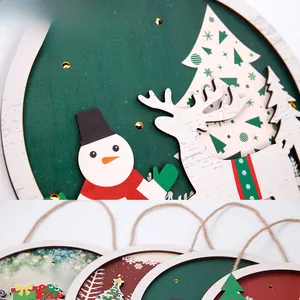Macro detail of layered wooden Christmas ornament featuring snowman and reindeer designs
