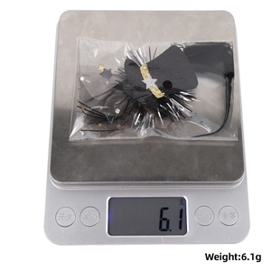 Detail view of a 2026 New Year crown hair clip on a digital scale weighing 6.1g