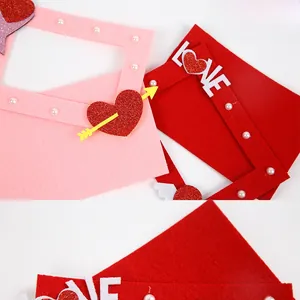 Detail of red and pink felt heart decorations with LOVE lettering for romantic frames