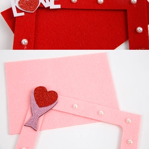 Detail of red and pink felt frames with LOVE glitter lettering and pearl accents