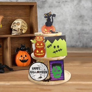 Macro detail of Halloween tiered tray decor featuring black cat and pumpkin wooden signs
