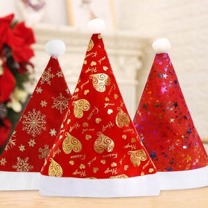 Detailed view of three festive red velvet Christmas hats with gold snowflakes and star patterns