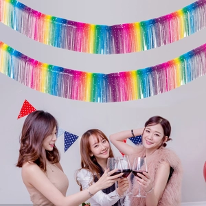 Rainbow gradient tinsel fringe curtain backdrop with white star accents for party decor