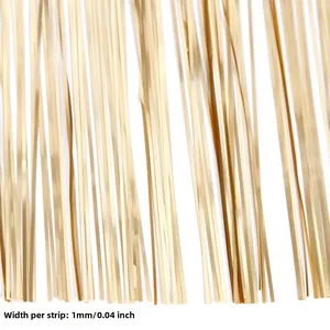 Macro detail of 1mm width matte gold tinsel curtain fringe for birthday party decorations