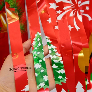 Detail of 2cm wide red metallic foil fringe curtain with festive Christmas patterns