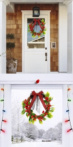 Christmas wreath with red berries, plaid bow and pine leaves displayed on a white door