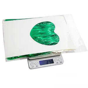 Close-up of green metallic twist ties in a 27g pack with heart-cutout card insert