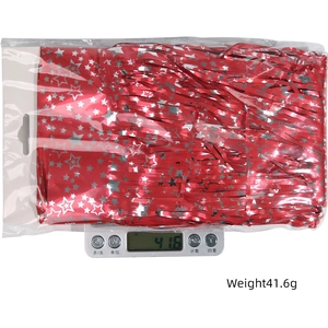 Detail of red tinsel curtain with silver stars in packaging, weighing 41.6g for party decor