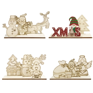 Detail of four DIY laser-cut wooden Christmas tabletop ornaments with festive designs
