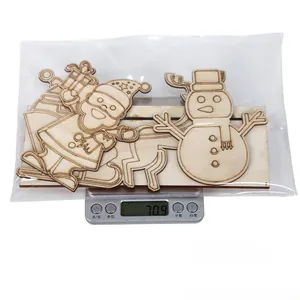 Laser-cut wooden Christmas ornaments with Santa and snowman in plastic bag on scale