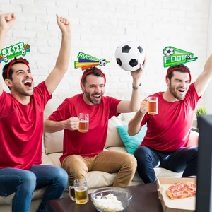 Three fans wearing soccer themed headbands with football and beer party props