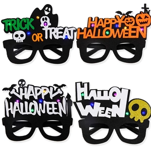 Detail of four LED Halloween party glasses with felt frames and festive motifs