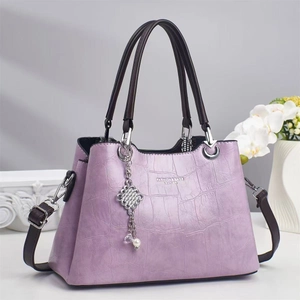 Sac à main violet élégant avec motif crocodile, pompon perle et bandoulière amovible