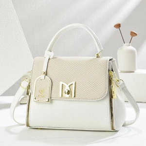 Minimalist white and beige crossbody handbag with golden M buckle and woven flap detail