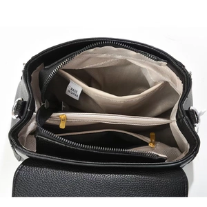 Interior view of black tote bag showing multiple compartments and tan lining details