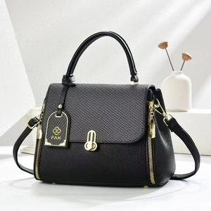 Elegant black crossbody handbag with gold hardware and textured leather finish
