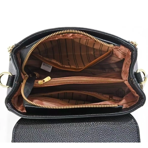 Interior view of black pebbled leather handbag with multi-compartment lining and gold hardware