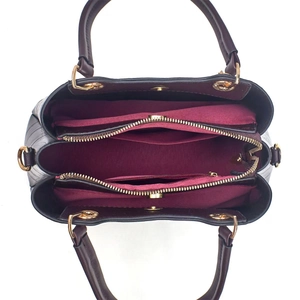 Top view of spacious burgundy leather handbag featuring organized interior compartments