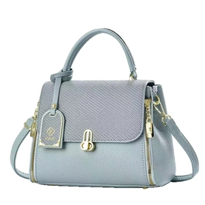 Gray-blue leather crossbody handbag with textured flap and elegant gold hardware details