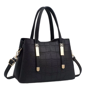Classic black handbag with crocodile texture and gold hardware for stylish women