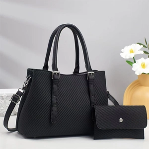 Minimalist black faux leather tote bag with matching wallet and adjustable shoulder strap