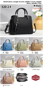 Macro shot of litchi texture leather handbag with triple-compartment interior and star charm