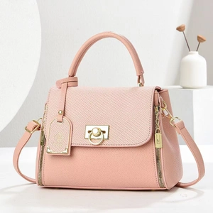 Pink lychee grain leather tote bag with gold hardware and top handle on a clean white background