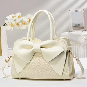 Cream white woven texture handbag with large bow decoration and gold chain strap
