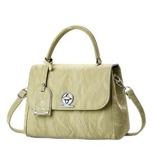 Elegant light green pleated handbag with silver twist lock and detachable shoulder strap