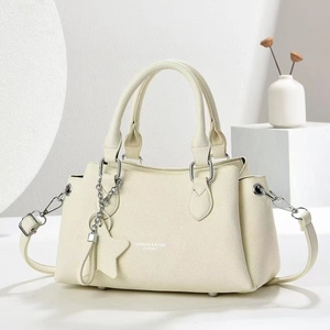 Fashionable beige lychee grain leather handbag with dual handles and crossbody strap
