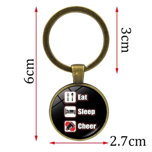 Eat Sleep Cheer keychain with bronze pendant showing dimensions of 6cm total length