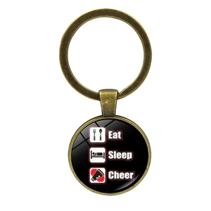 Eat Sleep Cheer keychain with glass dome pendant and silver alloy keyring on white background