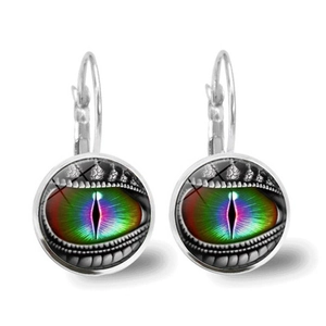Macro detail of vintage dragon eye earrings featuring rainbow iris and silver hooks
