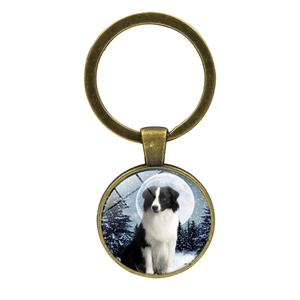 Border Collie dog glass cabochon keychain in bronze finish with snowy winter forest art
